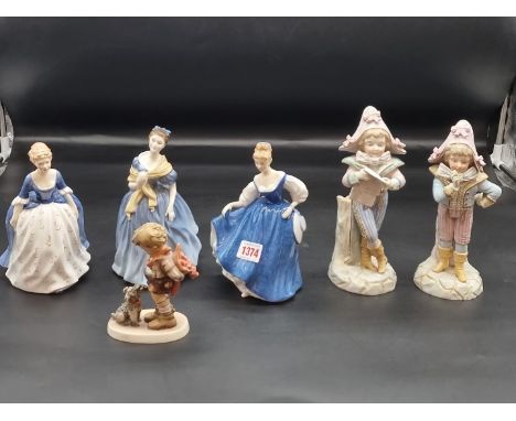 A pair of late 19th century French porcelain figural spill vases,&nbsp;22.5cm high; together with three Royal Doulton figures