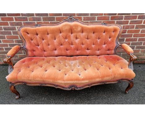A Victorian carved walnut and button upholstered settee,&nbsp;(faults). 