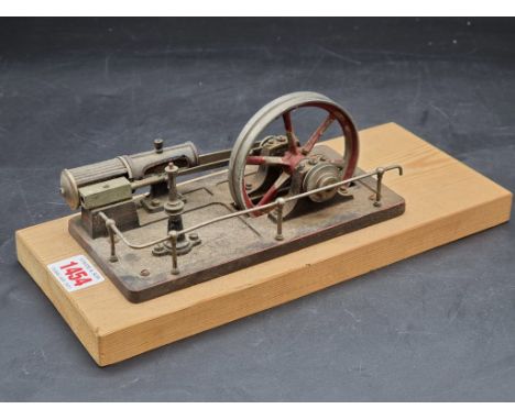 An old stationary steam engine, 18cm wide, on pine plinth.&nbsp; 