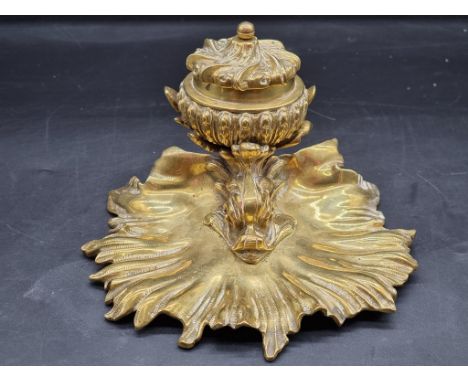 A rococo style brass dolphin and shell inkwell, 13.5cm high. 
