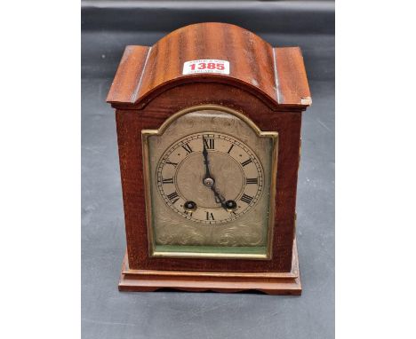 An early 20th century mahogany dome top mantel clock, with silvered dial, 18.5cm high, (chip to case).&nbsp; 