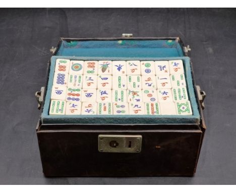 A vintage leather cased bone and bamboo mahjong set.&nbsp; 