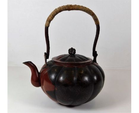 A Japanese bronze teapot with chased decor 8.25in tall to top of handle