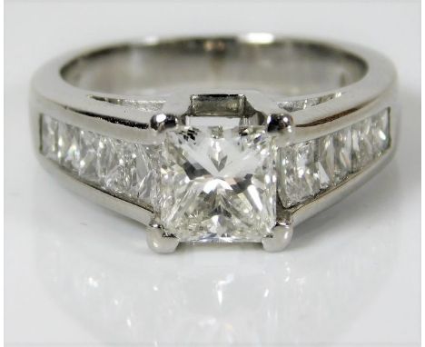 A platinum ring set with 1.07ct centre diamond with in excess of 1ct on shoulders 8.9g size K/L