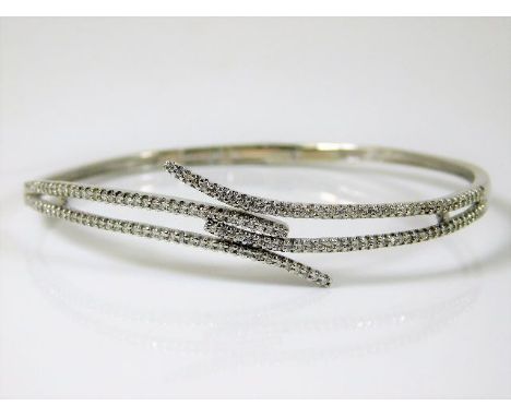 An 18ct white gold bangle set with approx. 1ct of diamonds 12.5g