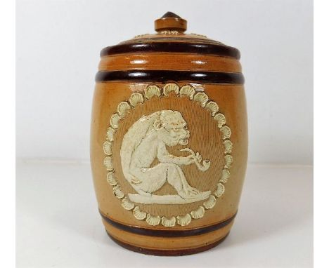 A Doulton stoneware tobacco jar with ape style figure smoking pipe 5.375in tall