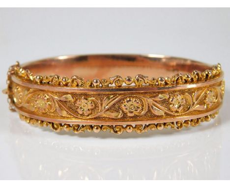 An antique decorative 9ct two tone rose gold bangle with box 13.3g