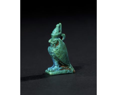 A vibrant blue-glazed amulet represents the falcon-headed god Horus, one of the most significant deities in ancient Egyptian 