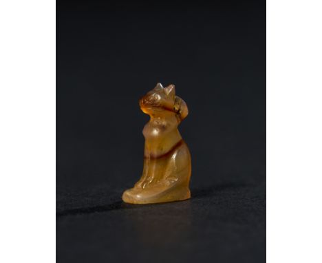 An Egyptian amulet made from banded agate, depicting a seated cat, a symbol of protection and fertility in ancient Egypt, clo