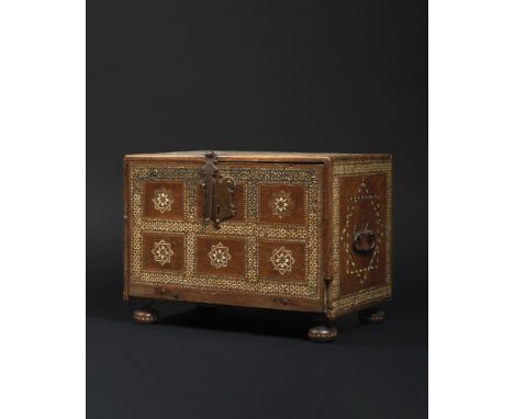 This elegantly designed cabinet features a rectangular shape and rests on four short, bulbous feet. The front and top are bea