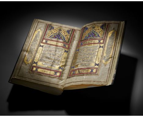 A 19th-century Qajar QurÃ¢â‚¬â„¢an features elaborate, illuminated pages framed by intricate geometric and floral designs typ