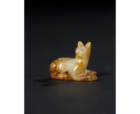 This elegant Egyptian amulet, carved from translucent agate, depicts a seated cat and dates back to the Late Period to Ptolem