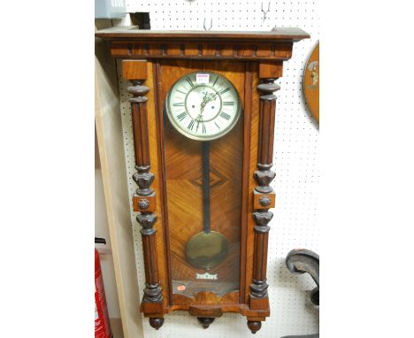 An early 20th century figured walnut Vienna drop trunk wall clock