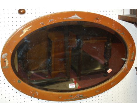 An early 20th century Japan lacquered bevelled oval wall mirror