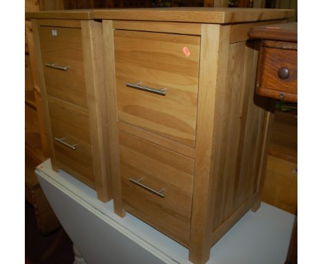 A pair of contemporary light oak two drawer bedside chests 