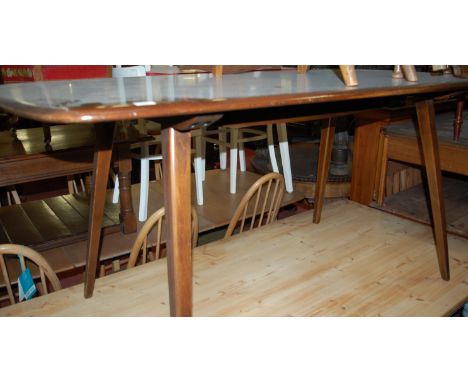 An Ercol dark elm dining table