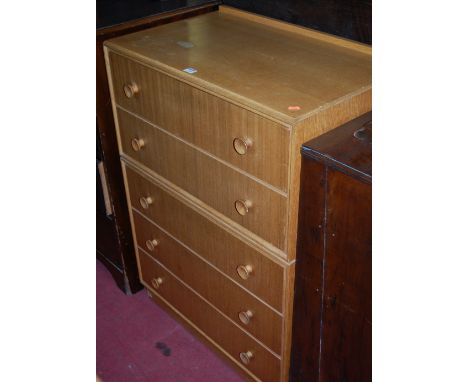 A 1960s light oak and teak ledgeback chest of five long drawers, w.77cm