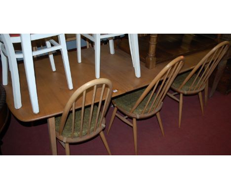 An Ercol light elm dining suite, comprising; extending dining table with hinged fold-out leaf (max length 222cm), and a set o