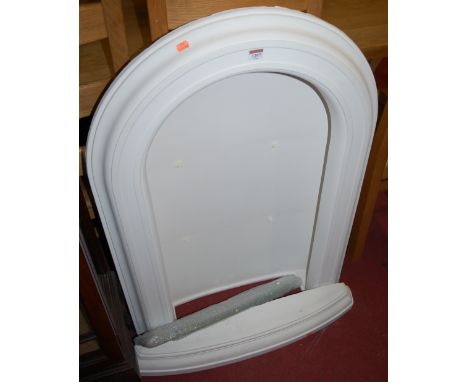 A white painted plaster open shelf in the form of a shrine