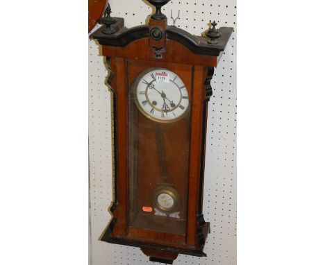 An early 20th century walnut Vienna drop trunk wall clock