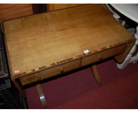 A Regency style oak and mahogany crossbanded two drawer dropflap sofa table