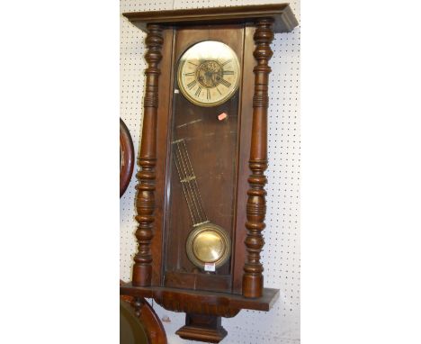 An early 20th century walnut Vienna drop trunk wall clock