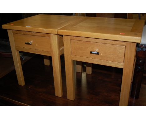 A pair of contemporary light oak single drawer bedside tables