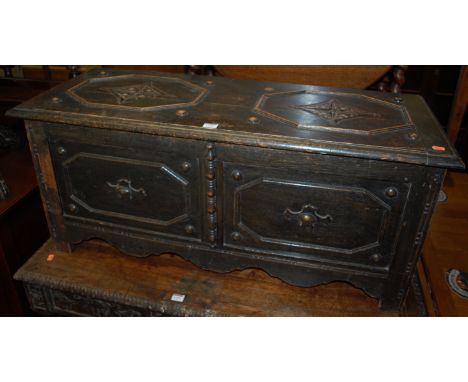 An early 20th century moulded oak hinge top twin panel blanket box, width 107cm