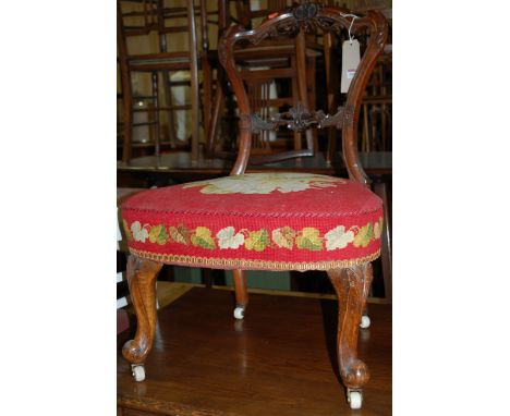 A Victorian walnut balloon back single salon side chair, having floral tapestry upholstered stuffover seat 