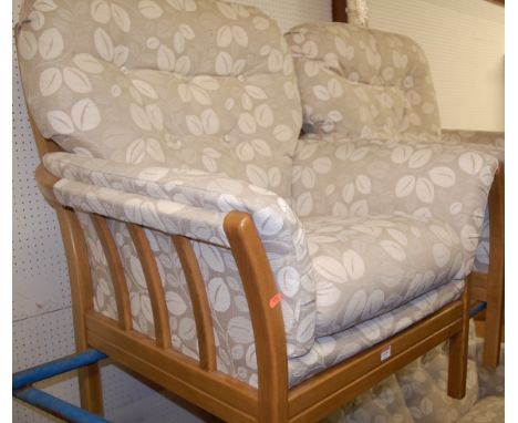 A contemporary light oak framed and button back upholstered three piece suite comprising two seater sofa and pair of armchair