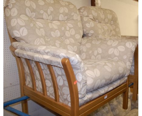 A contemporary light oak framed and button back upholstered three piece suite comprising two seater sofa and pair of armchair