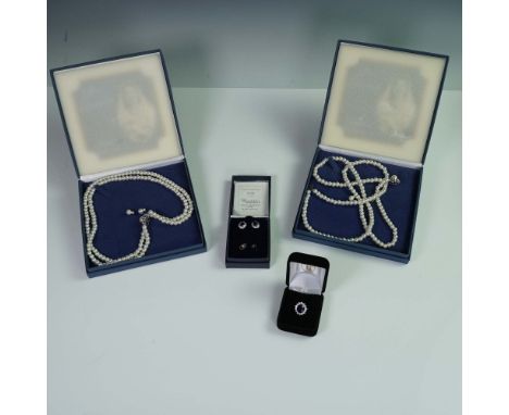 A collection of four Royal Family jewelry items including two faux pearl necklace and earrings sets that are replicas of Quee