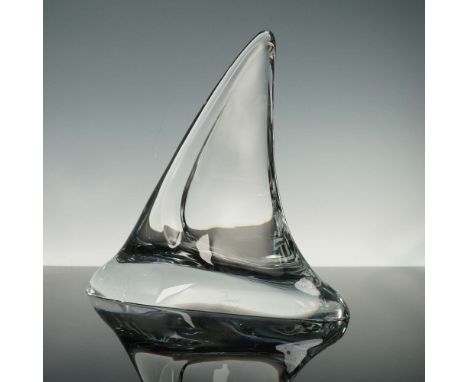 Modern sculpture showcasing a striking abstract form with a sweep curve rising from a smooth base, evocative of a fin cutting