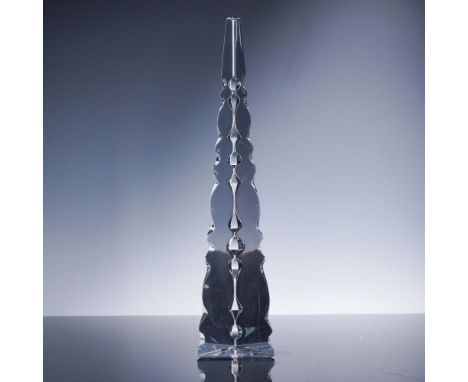 Triangular obelisk sculpture produced by Baccarat Crystal, France. The solid clear crystal form features faceted and undulati