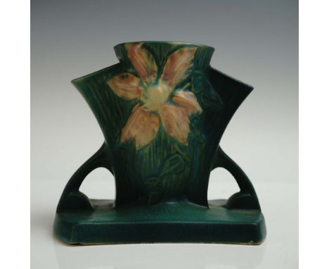 Amiable pottery bud vase featuring a sculptural floral design with pale pink clematis blooms in raised relief on both sides, 