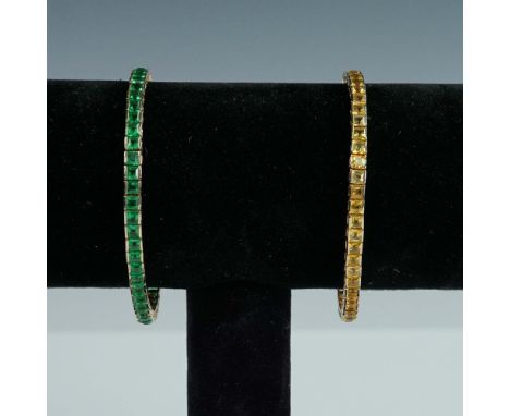 Pair of tennis bracelets made of gilt sterling silver, each marked 'NLH' and '925' on the clasp. One bracelet is set with uni