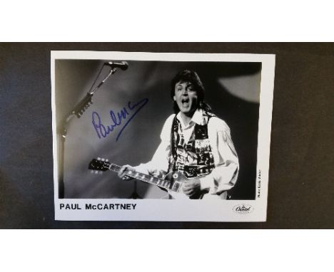 POP MUSIC, signed promotional photo by Paul McCartney, half-length playing bass, 10 x 8, with press release for 1993 CD relea