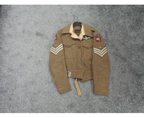 A British Army Battle Blouse with earlier Glider Pilot Badges including Wings, Glider Pilot Regt, Pegasus, Sergeants Stripes,