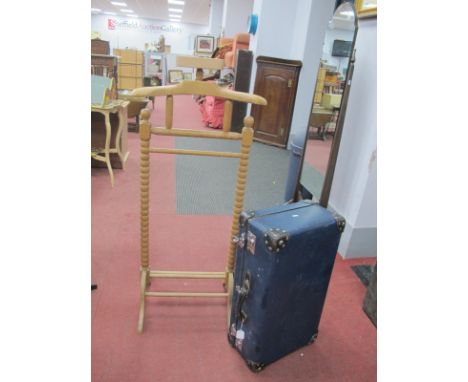 Freestanding Valet with Bobbin Supports, coat hangers, globe trotter suitcase.