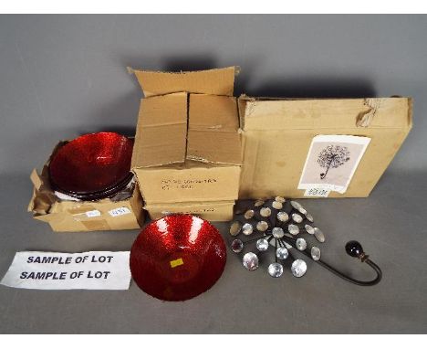 Unused Retail Stock - Sixteen red modern decorative glass bowls and a metal wall art item with hanging hook with some marks.(