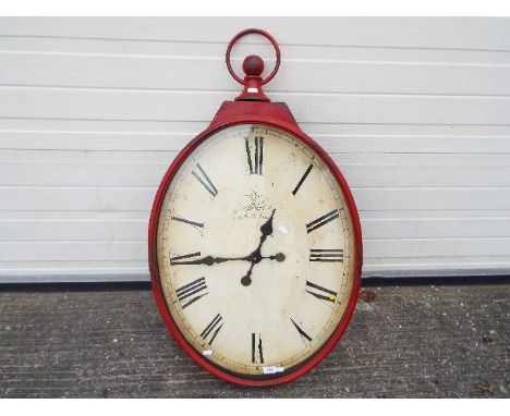 A large, decorative wall clock, approximately 95 cm x 56 cm.