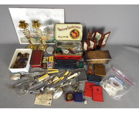 A mixed lot of collectables to include cigarette cards, coins, flatware (some with silver mounts), vintage tins, candlesticks