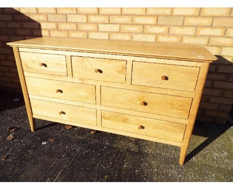 A good quality, light oak, sideboard by J. B. Global, approximately 79 cm x 138 cm x 43 cm