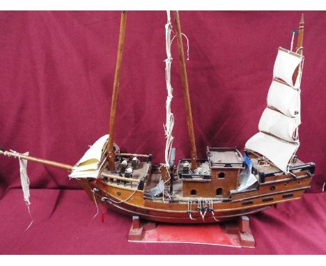 A static wooden model of a Chinese Junk. The model made from mahogany measures on stand approximately 86cms (H) x 121cms (L) 