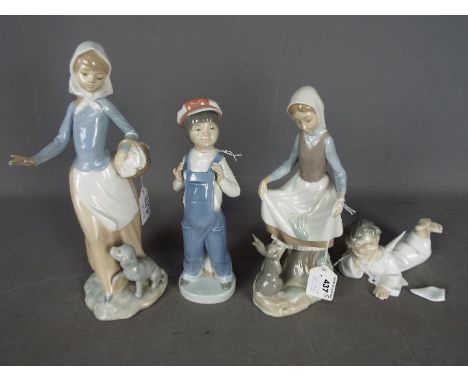 Lladro - Two Lladro figurines including a girl with a rabbit and a boy in dungarees, a Nao figurine of a girl with a dog and 