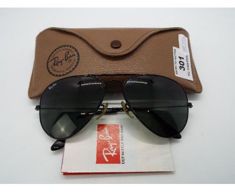 A pair of Ray-Ban sunglasses, model RB3052, left lens etched 'BL', with leaflet and case.