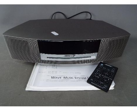 A Bose Wave Music System III with power cable, instructions and remote.Condition Report: Machine powers on when plugged in, t