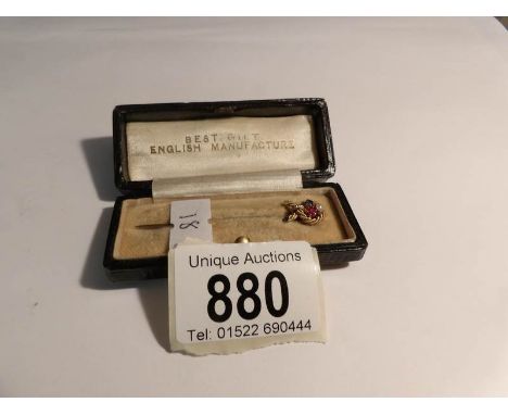 A cased gold stick pin set ruby, seed pearl and sapphire