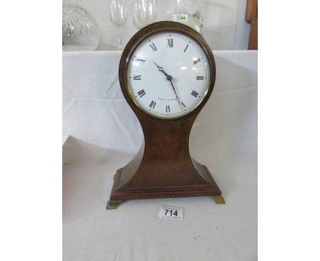 A mahogany 'balloon' cased mantel clock, in working order