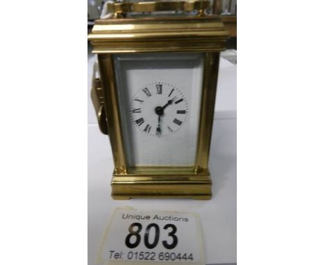 A small brass carriage clock in working order and complete with key